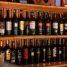 A stylish arrangement of wine bottles showcased on wooden shelves in a bar setting.