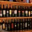 A stylish arrangement of wine bottles showcased on wooden shelves in a bar setting.