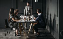 A sophisticated wine tasting event with diverse adults enjoying drinks indoors.