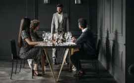 A sophisticated wine tasting event with diverse adults enjoying drinks indoors.