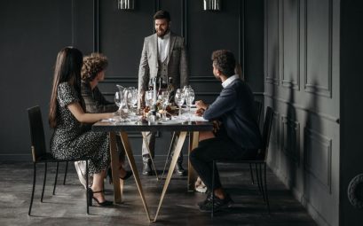 A sophisticated wine tasting event with diverse adults enjoying drinks indoors.