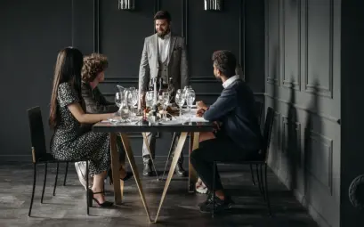 A sophisticated wine tasting event with diverse adults enjoying drinks indoors.