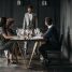 A sophisticated wine tasting event with diverse adults enjoying drinks indoors.