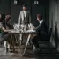A sophisticated wine tasting event with diverse adults enjoying drinks indoors.