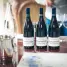Elegant wine tasting setup in Beaune, featuring French wine bottles and glasses on a table.