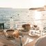 Seaside dinner in fira, greece during golden hour