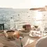 Seaside dinner in fira, greece during golden hour