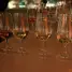 Several glasses of amber liquid on a bar